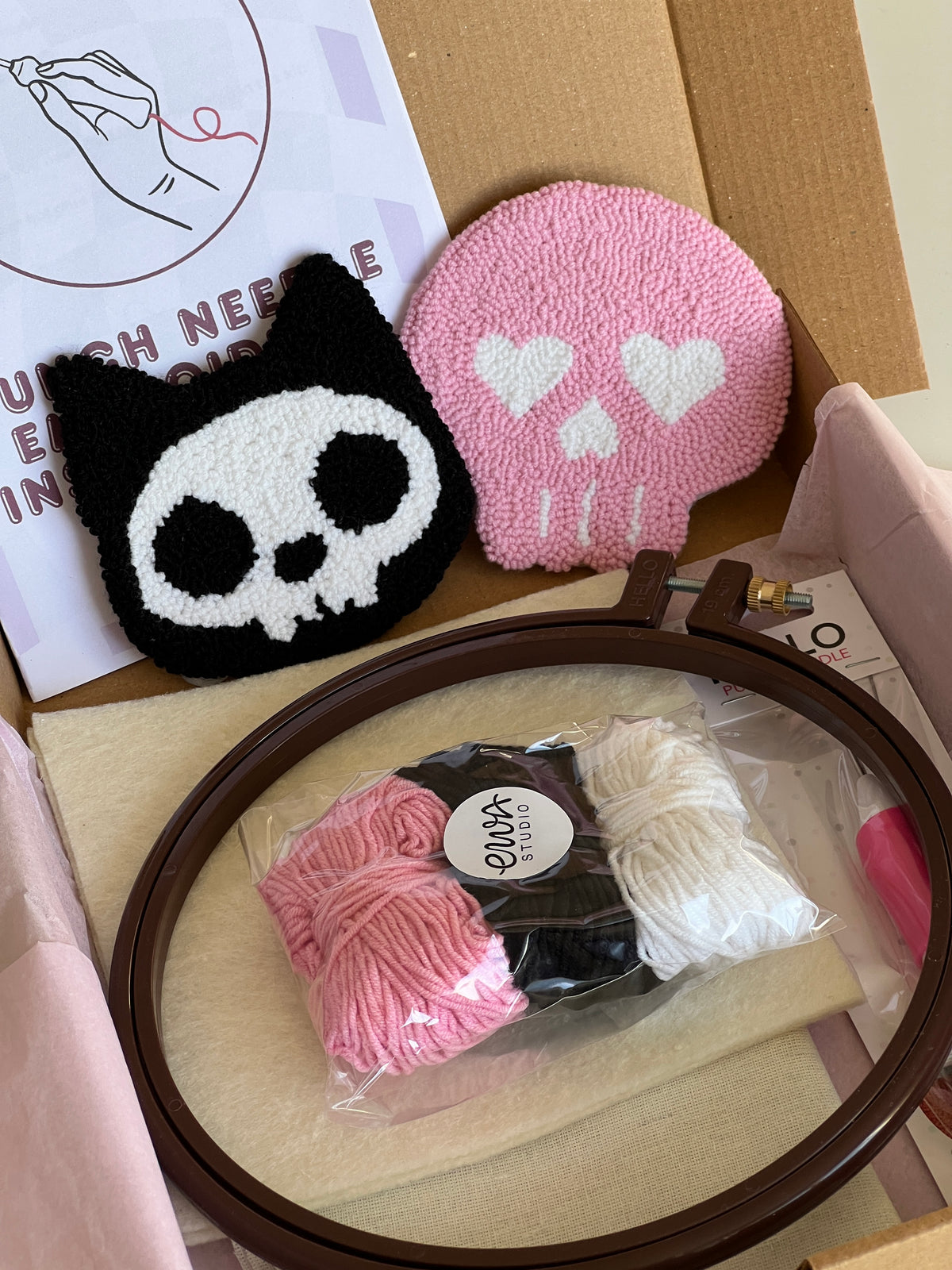 Punch needle kit box with cat skull and pink skull coasters, yarn, hoop and needle