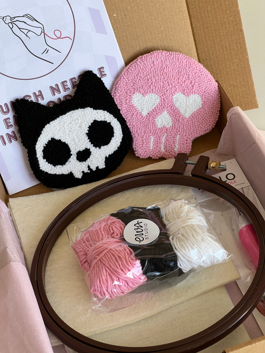 Punch needle kit box with cat skull and pink skull coasters, yarn, hoop and needle