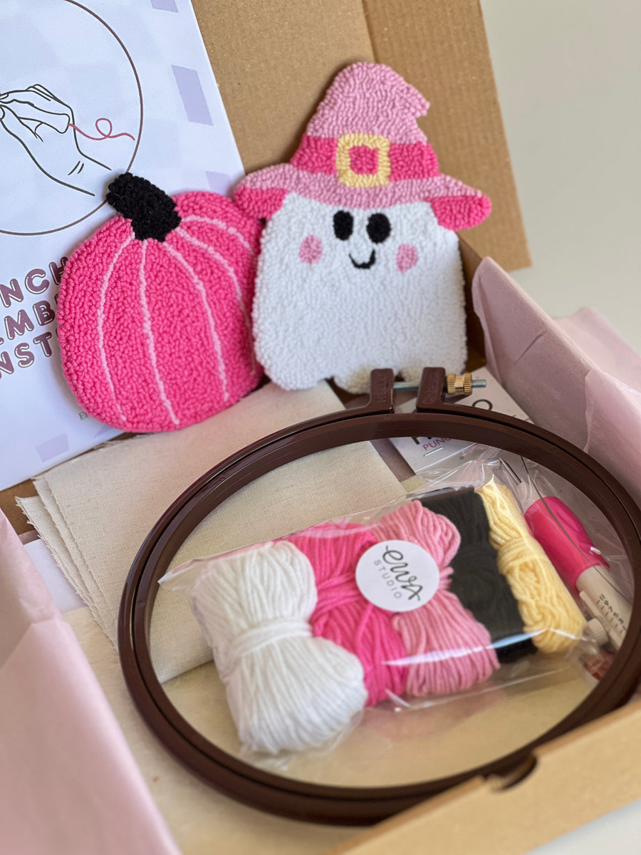 Punch needle kit box with pink pumpkin and witch hat ghost coasters, yarn, hoop and needle