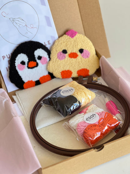 Punch needle kit box with chick and penguin coasters, yarn, hoop and needle
