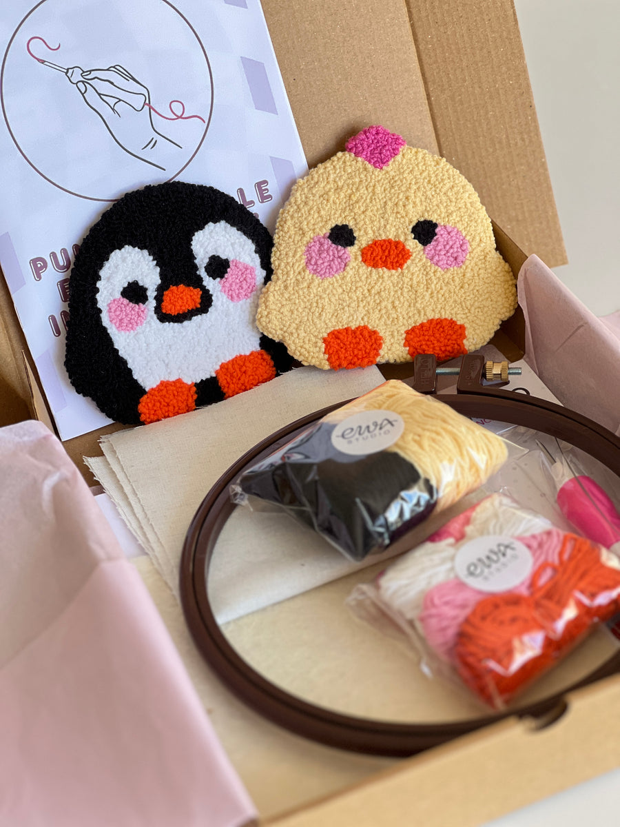 Punch needle kit box with chick and penguin coasters, yarn, hoop and needle