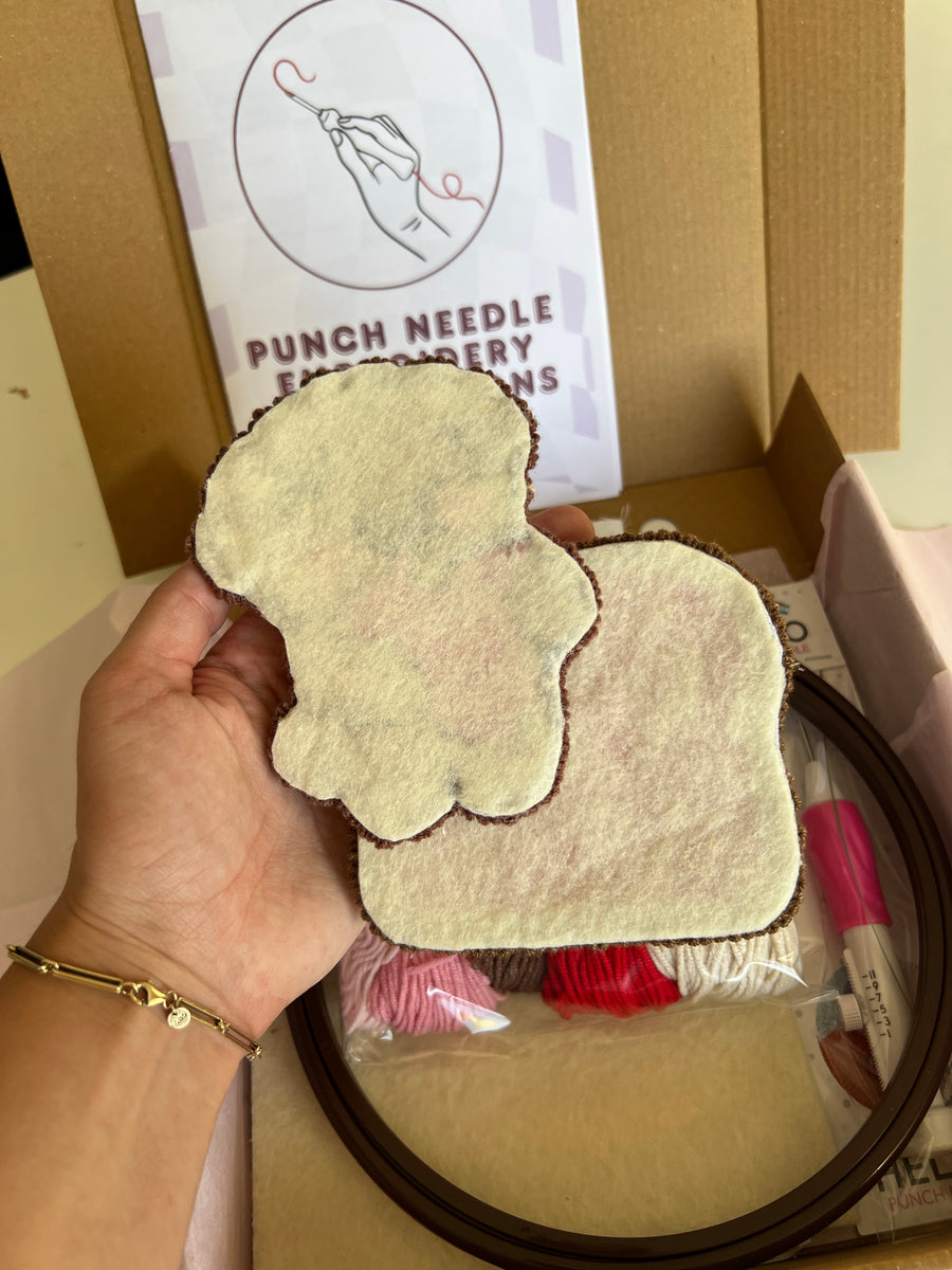 Felt backing on the reverse of two finished punch needle coasters