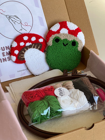 Punch needle kit box with frog and mushroom coasters, yarn, hoop and needle