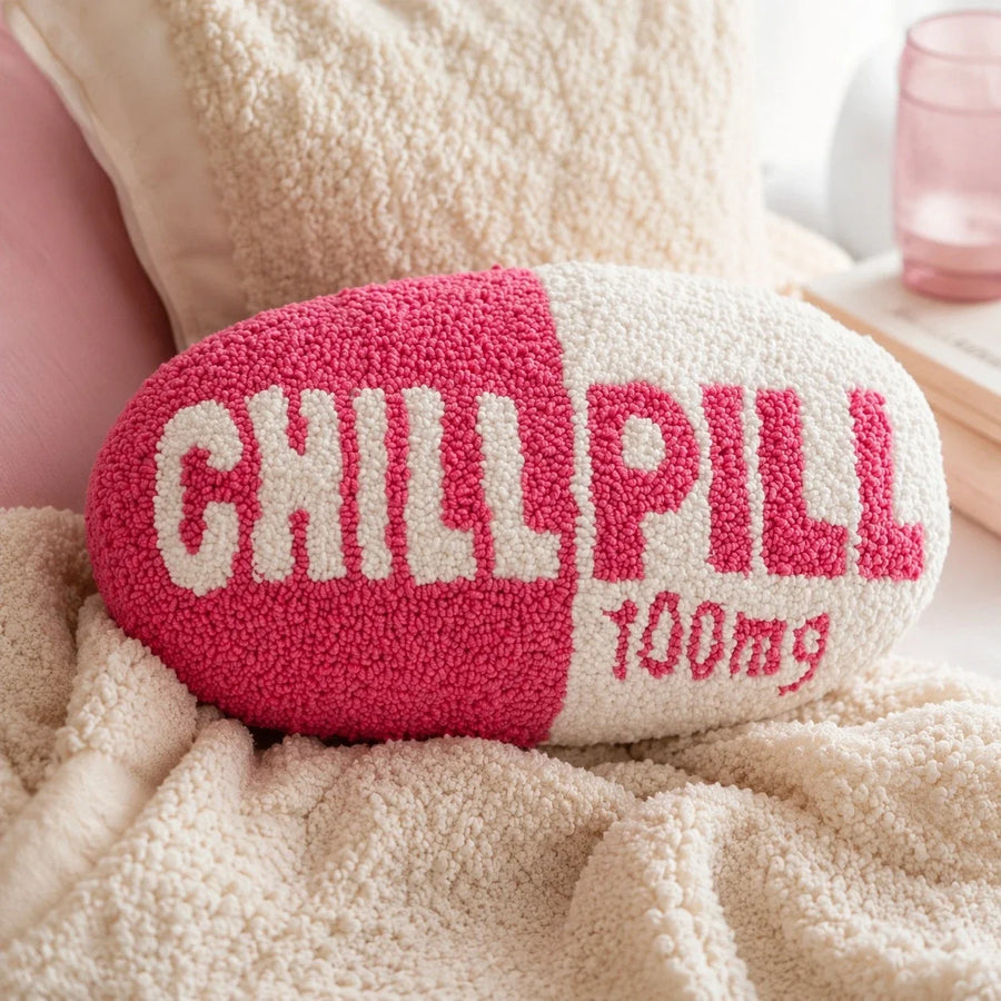 Close-up of the Chill Pill pillow punch needle texture on a cream chair