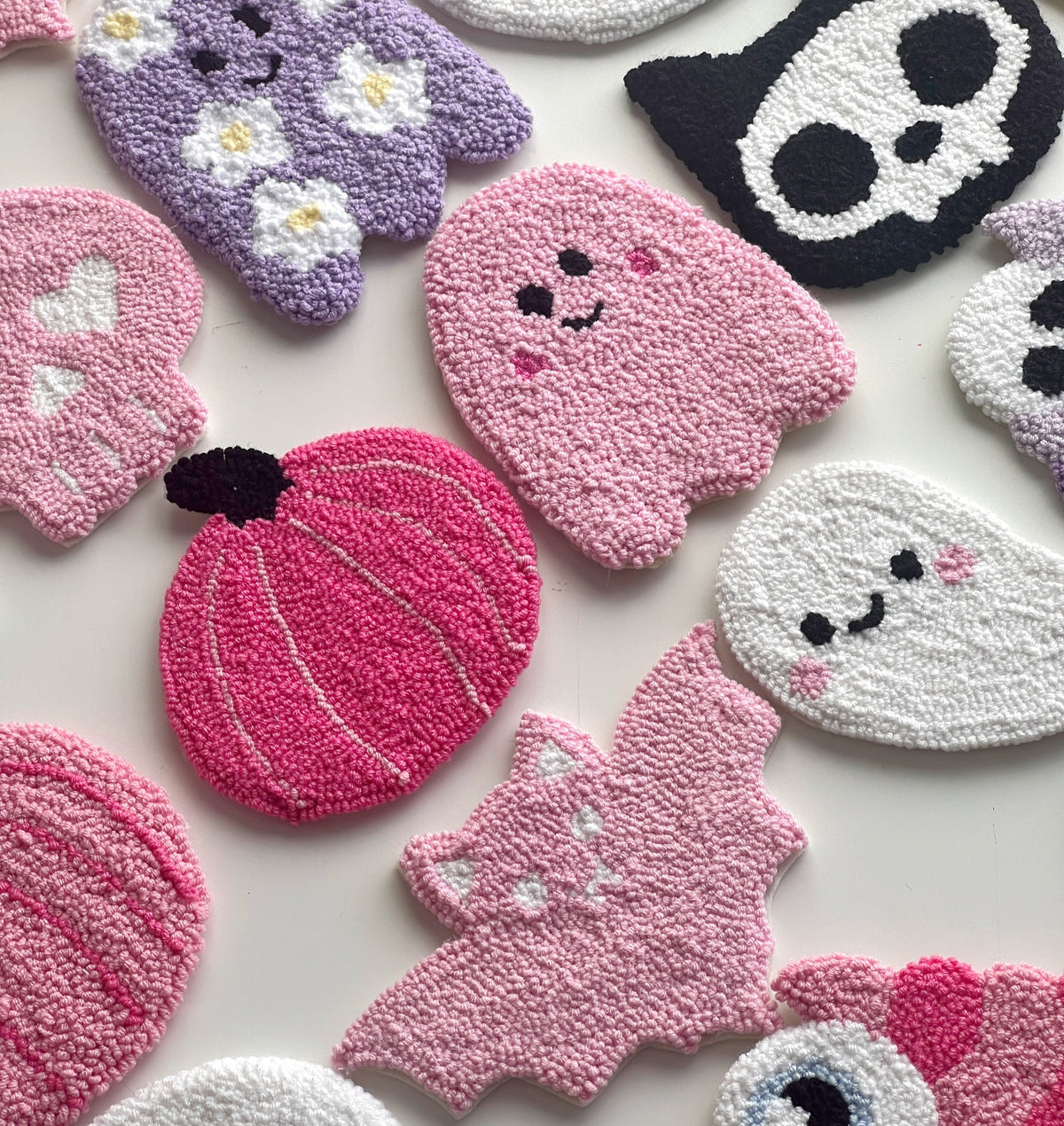 Pink Halloween mug rugs: ghosts, a pumpkin, a bat and a skull cat